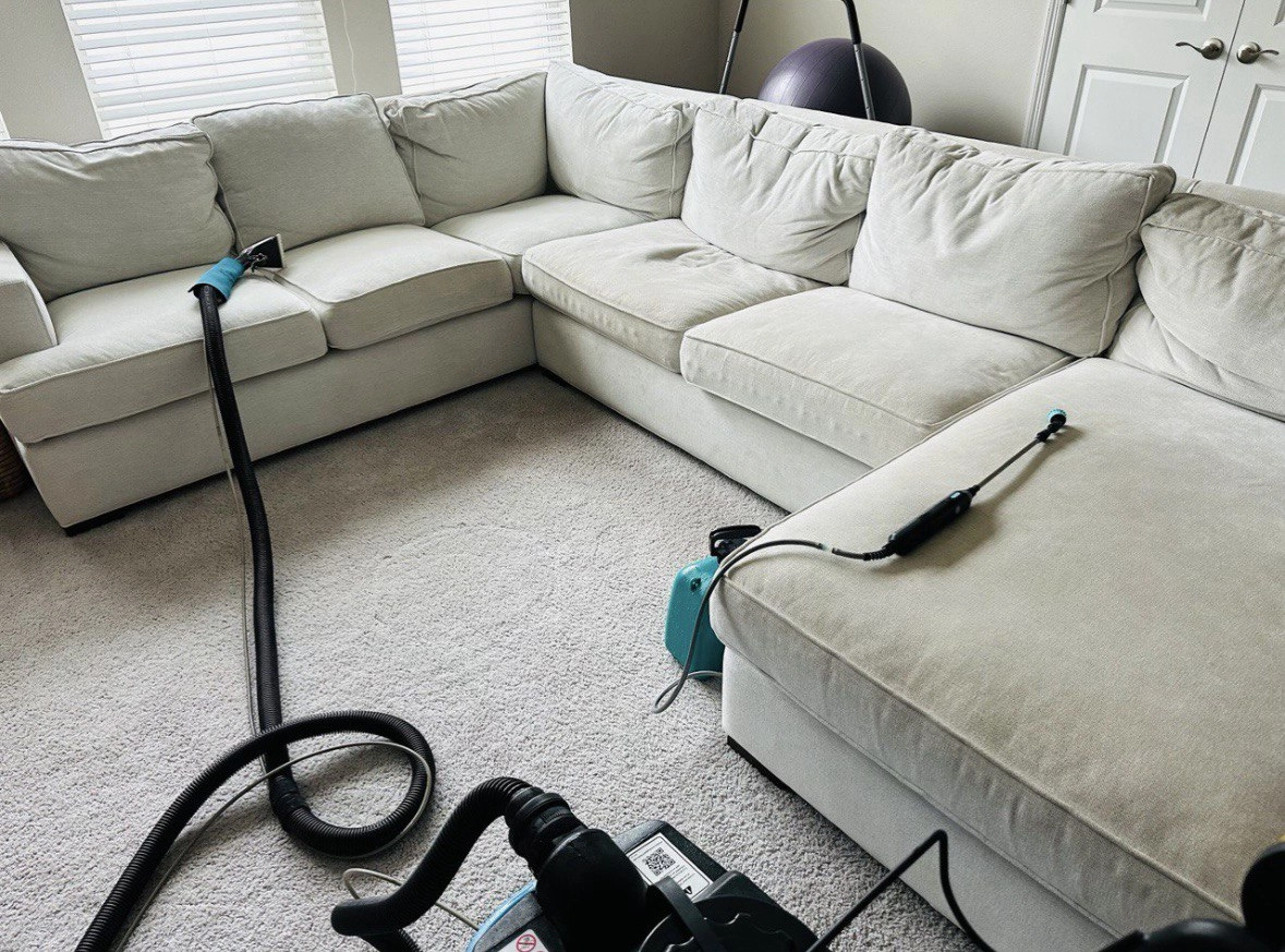 Upholstery cleaning in progress on sectional seating