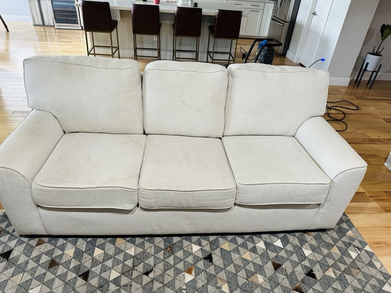 Three-seat sofa before and after upholstery cleaning