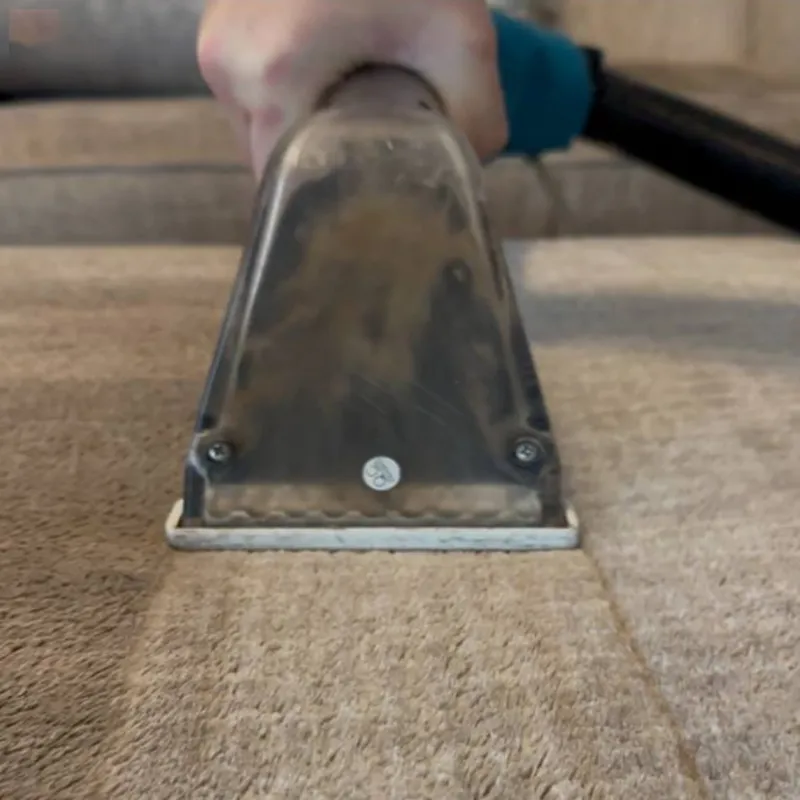 Steam extraction tool in use on a dirty carpet