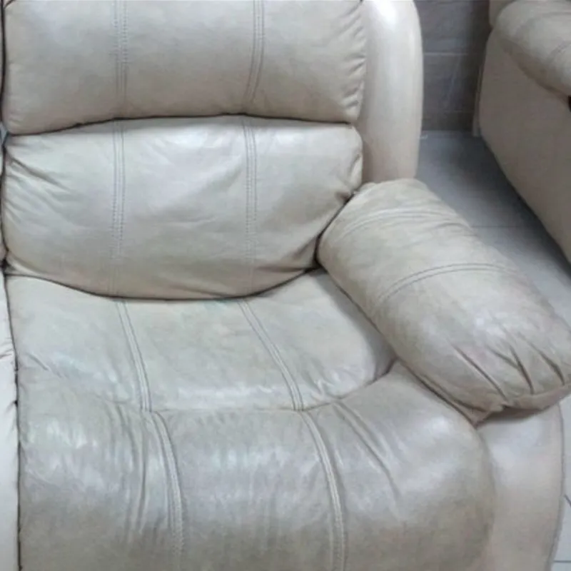 Worn leather recliner with heavy grime buildup