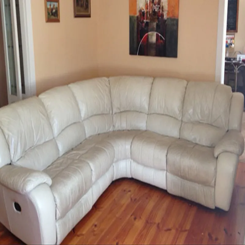 Sectional leather couch with visible dirt and oil